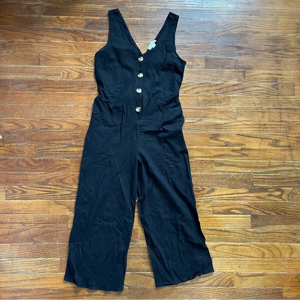 Black romper with buttons.